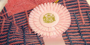 Crochet item with ribbon.