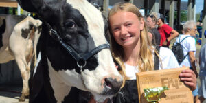 Kids and cow with a prize.