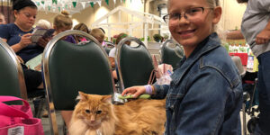 Kid with a show cat.