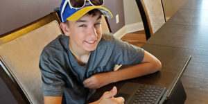 Teen working at a laptop.