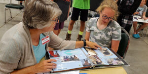 Adult and child looking at a book.