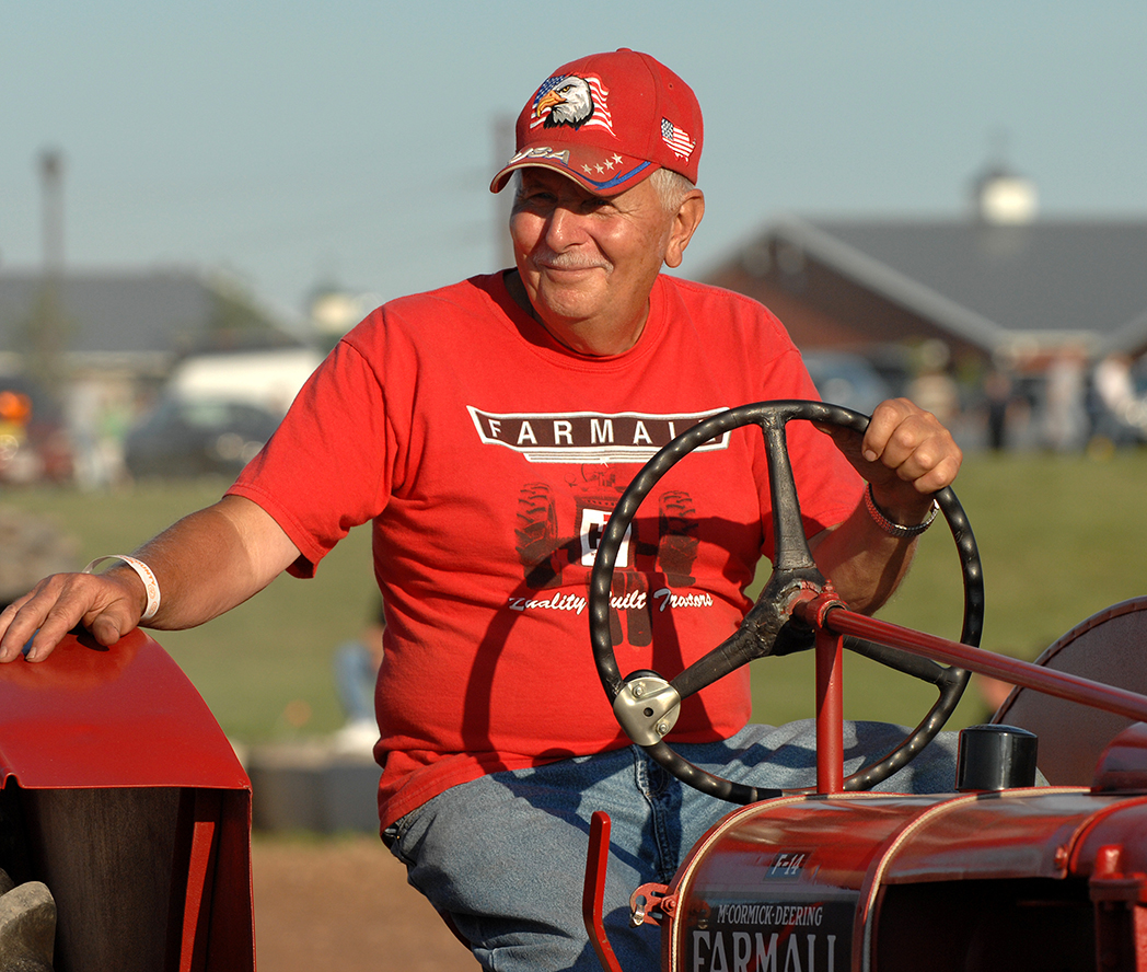 Man driving a farm tractor.